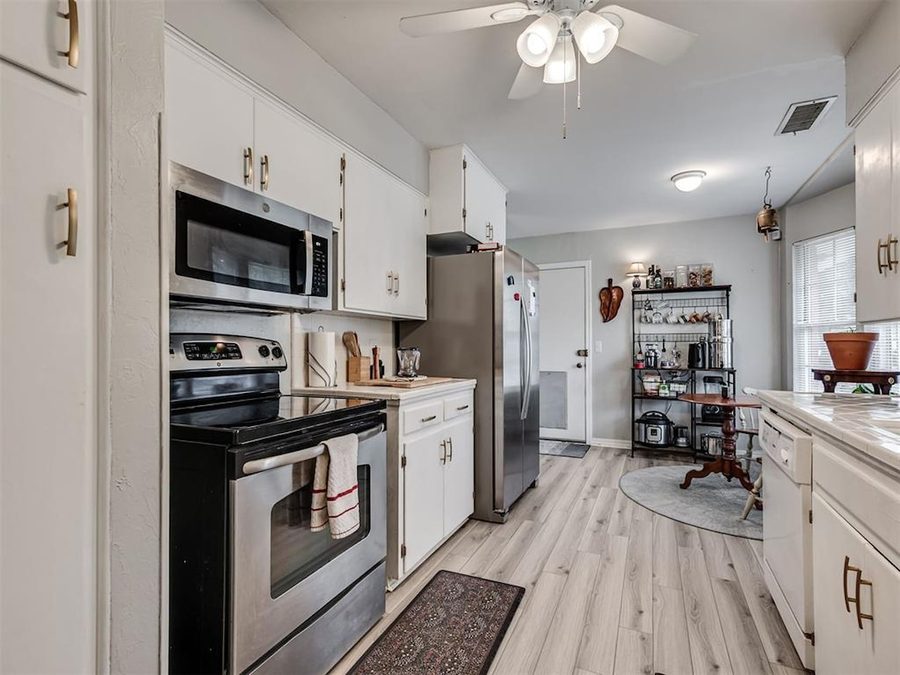 White kitchen with stainless appliances