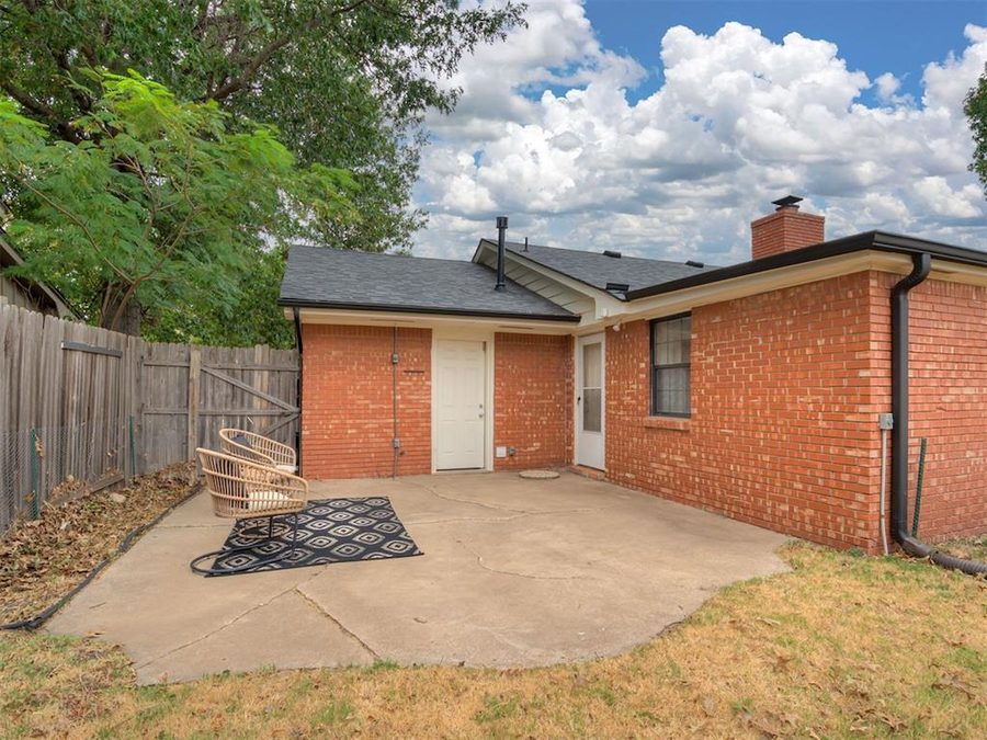 Back patio and fenced backyard