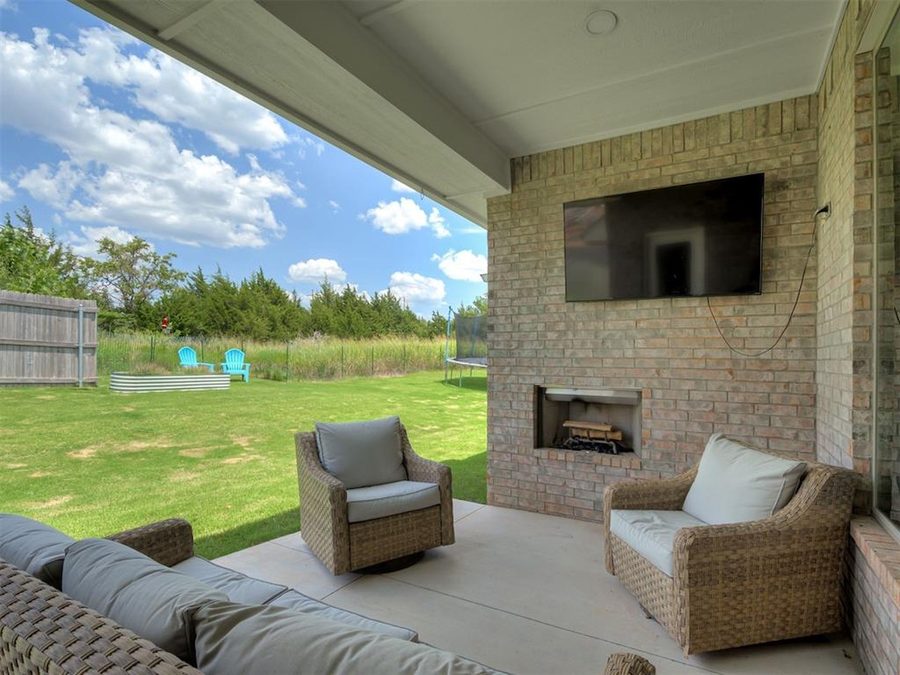 Covered patio with wood-burning fireplace
