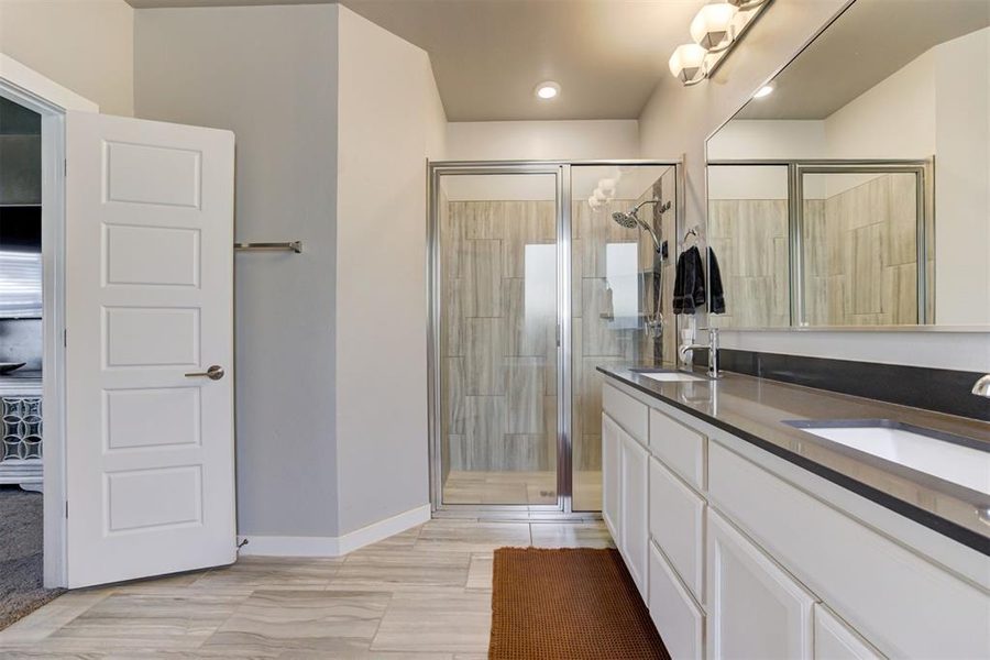 Primary bath with dual sinks and walk-in shower